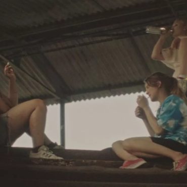 Three Girls drinking and smoking outside