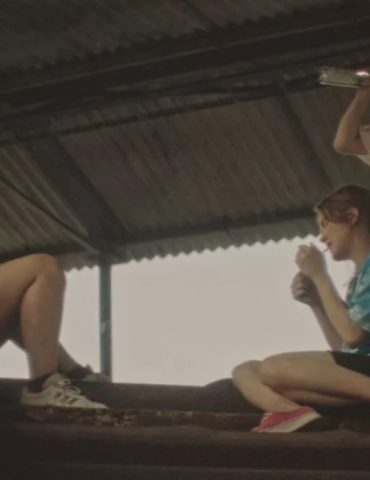 Three Girls drinking and smoking outside