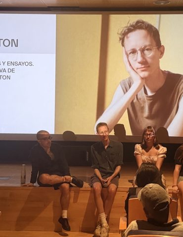 Filmmaker Charlie Shakleton on a stage dudring a Q&Q with three other people and some members of the audience.